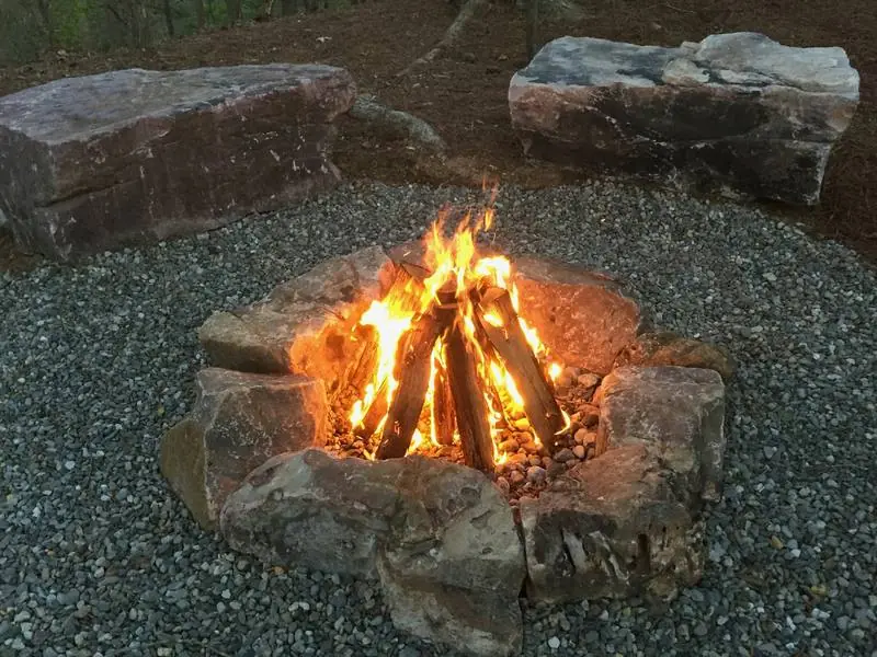 A stone fire pit with boulder seating.